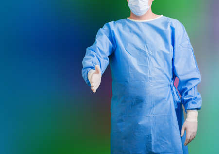 a surgeon in uniform with mask and glovesの写真素材