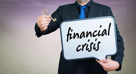 a businessmann with a whiteborad text is financial crisis