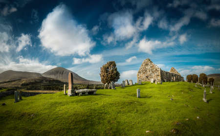 old cemetery in scotlands highlands. green grass and blue skyeの写真素材