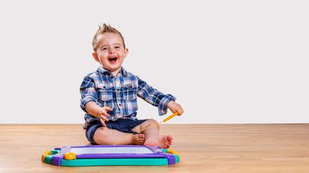 sitting smiling boy at the bottomの写真素材