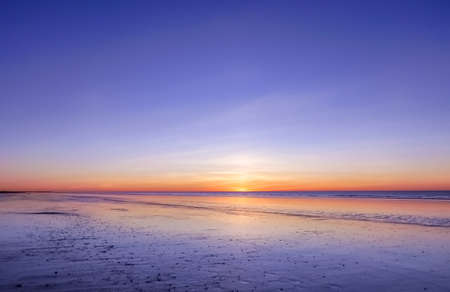 panoramic view of sunset over ocean. Nothing but sky, clouds and water. Beautiful serene scene