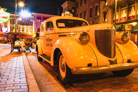 OSAKA, JAPAN - AUGUST 10, 2019: Night view of Yellow cab at NEW YORK AREA in Universal Studios Japan. Universal Studios Japan is a fun and fame park in Japan.のeditorial素材