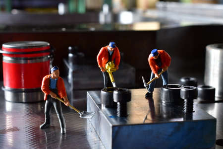 Miniature Workers on Sheet Metal Stamping Tool Die for Automotive Precision Parts on the Numerical Control Milling Machine Table. Tandem Stamping System. At a High Quality Technology Factory.の写真素材