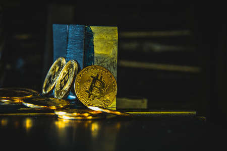 Virtual cryptocurrency money Bitcoin golden coin on metal plates of car part. The future of money. Computational equipment. Blue mother board. Shot directly from above.の写真素材