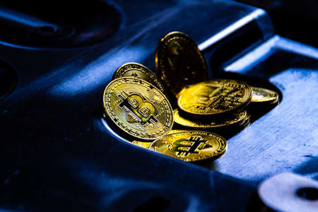 Virtual cryptocurrency money Bitcoin golden coin on metal plates of car part. The future of money....