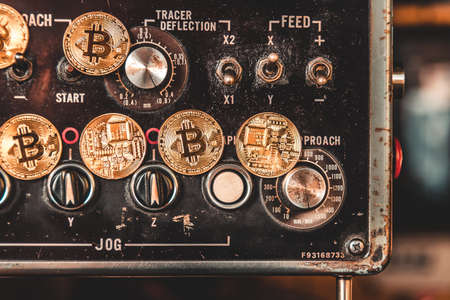Virtual cryptocurrency money Bitcoin golden coin on Machine controller plates of car part. The future of money. Computational equipment. Blue mother board. Shot directly from above.の写真素材