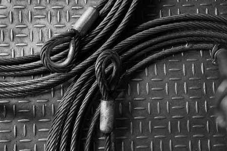 Iron wire rope placed on striped steel plate. Black and white photo. Conceptual images of...