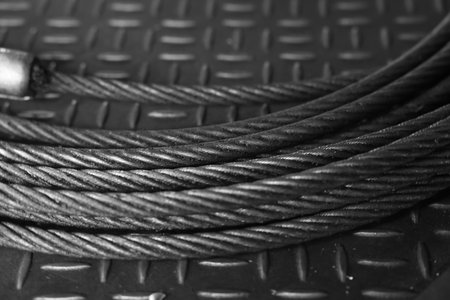 Iron wire rope placed on striped steel plate. Black and white photo. Conceptual images of...