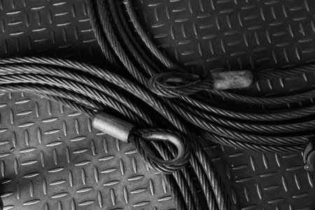 Iron wire rope placed on striped steel plate. Black and white photo. Conceptual images of...