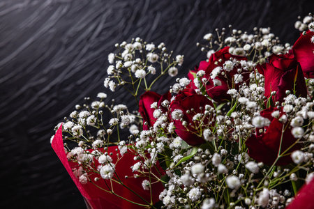 Roses and hazel on black background under spotlight. Concept photos for wedding anniversaries, entrance ceremonies, and acceptance announcements.の写真素材