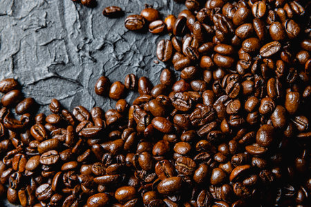 Roasted coffee beans on black design board.の写真素材