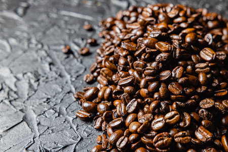 Roasted coffee beans on black design board.の写真素材