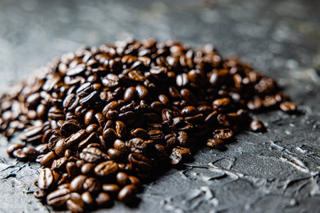 Roasted coffee beans on black design board.の写真素材