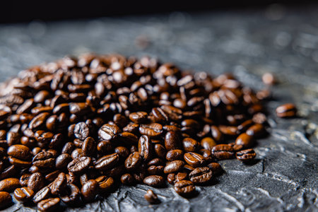 Roasted coffee beans on black design board.の写真素材