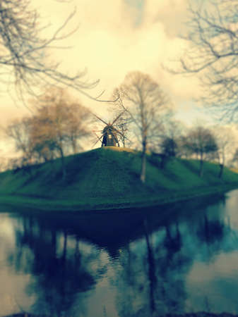 Windmill reflection on an island in summertime.の写真素材