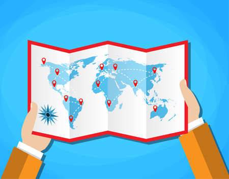 Cartoon hands hold folded paper map of world with color point markers. World map countries. vector illustration in flat design on blue backgroundのイラスト素材