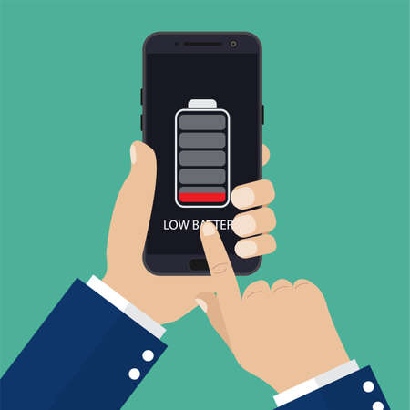 Hand holding smartphone with low battery