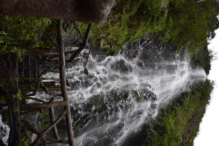 a small stone pool with a waterfall near Banos, Ecuador