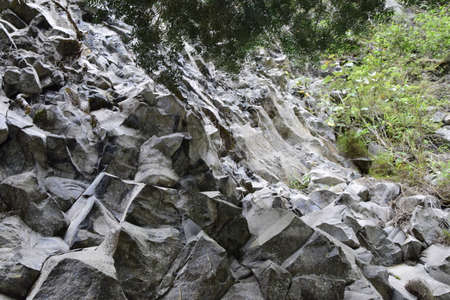 carved rock next to Pailon del Diablo - Mountain river and waterfall in the Andes. Banos, Ecuador