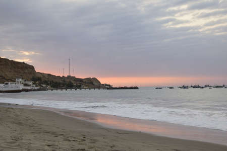 sunset over mancora beach with fisher boats, peru.の写真素材