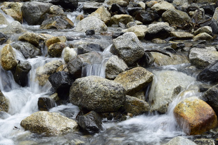 A stormy mountain river flows through the rocks, on the way to Lagoon 69. Huascaran National Park in the Sands of Peru.の写真素材