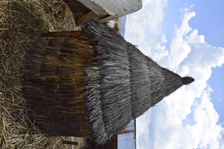 Floating islands near Puno city, Buildings and houses made of straw on the floating islands of Lake Titicaca. Puno, Peru.の写真素材