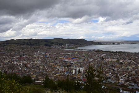 View from a high point of Lake Titicaca and the city of Puno, Peru.の写真素材