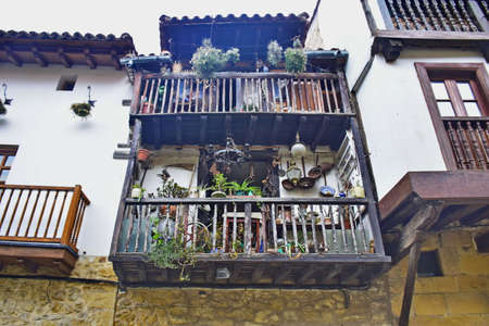 Spain - 14 October 2019: Potted flowers on a wooden balcony, in the ancient town. The Way of St. James, Northern Route, Spainの写真素材