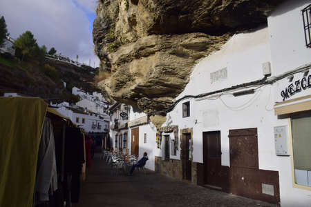 Setenil de las bodegas, Spain - 08 november 2019: Street with dwellings built into rock overhangs above Rio Trejo. Andalusia. Spain.のeditorial素材