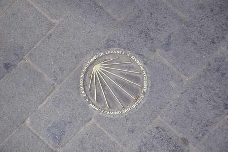 Valencia, Spain - 11 november 2019: The sign of the direction of the way of St. James on the sidewalk.の写真素材
