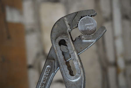 Coin one Russian ruble clamped in a pincerの写真素材
