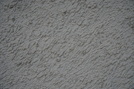 A fragment of a light wall with a plastered surface.の写真素材