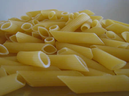 penne pasta in foregroundの写真素材