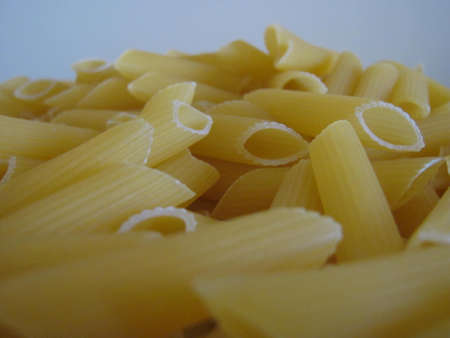 penne pasta in foregroundの写真素材