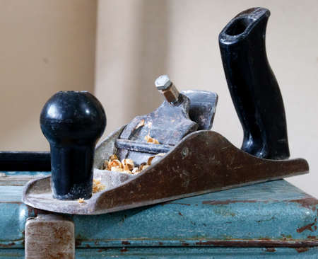 antique wood plane with sawdustの写真素材