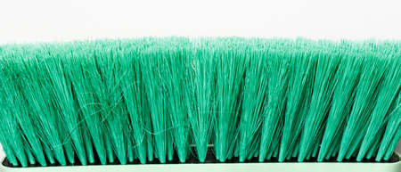 green cleaning brush on white background
