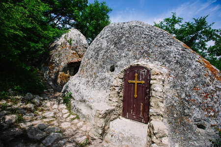 A door with a cross at the entrance to the stone Churchの写真素材