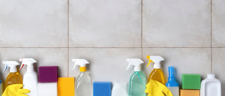 House cleaning products on the tile wall. Cleaning service concept.の素材