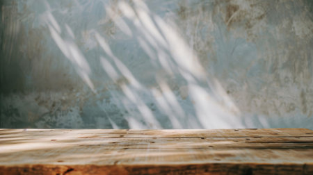 A wooden table in a garden or outdoor setting with a distinct shadow of a tree cast upon its surface. The shadow creates a unique and interesting pattern on the table, adding a natural element to the scene.の素材