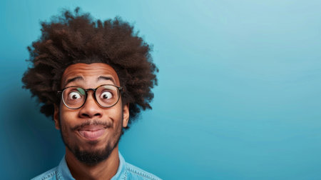 A man with a surprised expression on his face, eyebrows raised, eyes widened. He appears shocked by something he is looking at.の素材