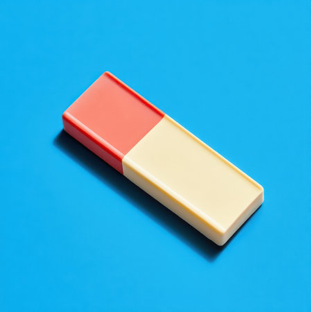 A rectangular eraser with a red and yellow design rests on a bright blue background showcasing its sleek and modern appearance.の素材