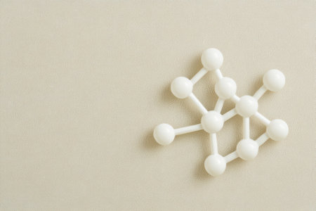 A white molecular model showcases spheres connected by rods emphasizing chemistry concepts on a neutral backdrop ideal for educational use.の素材