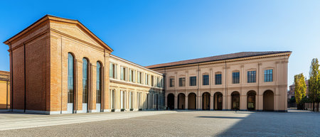Bright sunlight illuminates the elegant buildings surrounding a spacious courtyard showcasing distinct architectural styles and materials.の素材