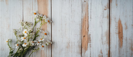 Wildflowers including daisies rest against a rustic wooden surface showcasing a natural and tranquil atmosphere.の素材
