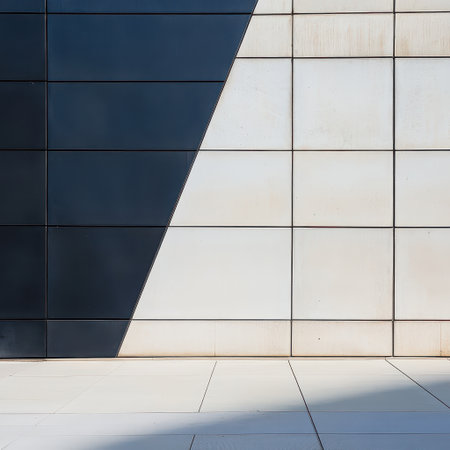 A sleek urban wall showcases a blend of dark and light tiles emphasizing geometric patterns and clean lines in a contemporary setting.の素材