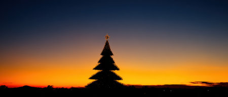 As the sun sets a modern poundal stands silhouetted against a vibrant sky. This festive scene captures the joy of holidays and New Year spirit.の素材