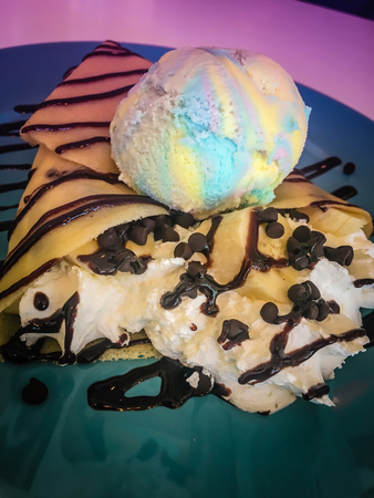 Cold crepe with chocolate, vanilla ice-cream and mousse on dish.の写真素材