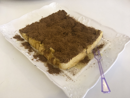 Toast with ovaltine, condensed milk in dish and plastic flower.の写真素材