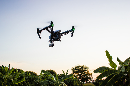 Professional camera drone flying in nature with clear sky.の写真素材
