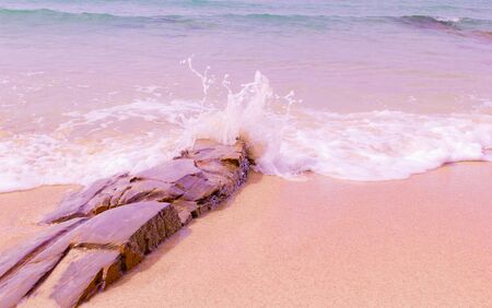 Rock on the beach and soft wave.
